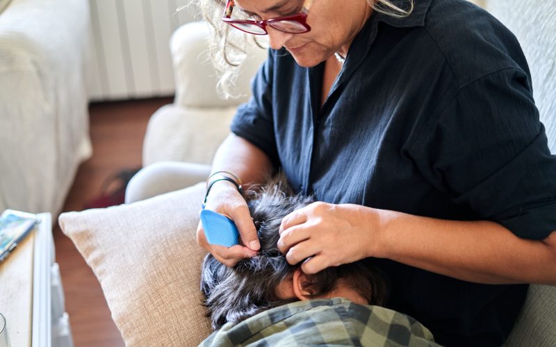 A Woman Undergoing a Haircut with an Anti Lice Treatment
